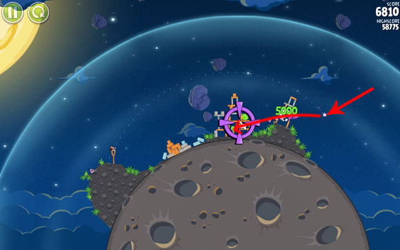 Once it's at the indicated spot, turn it in the direction of the structure with three pigs in it, so that it passes through the planks supporting the pig on the right - Level 1-22 - Pig Bang - Angry Birds Space - Game Guide and Walkthrough