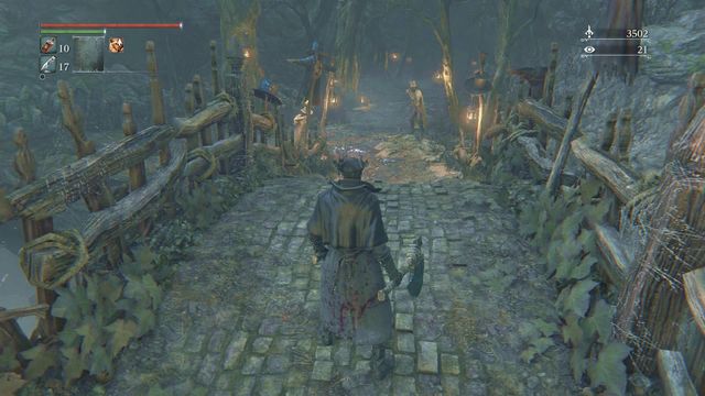 Behind the bridge, there are two enemies and a trap set on the tree to on the right side of the road. - Forbidden Woods - Walkthrough - Bloodborne - Game Guide and Walkthrough