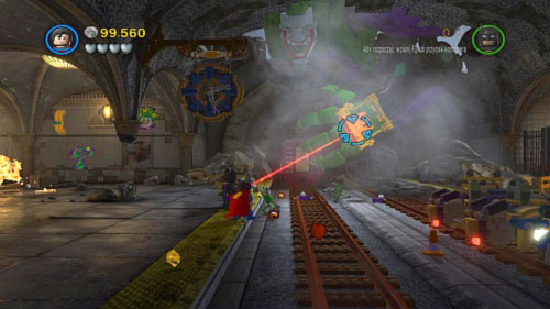 Go to the rails on the right and when robot's arm will show up start shooting golden point on hand using Superman's laser (picture) - Underground Retreat - Walkthrough - LEGO Batman 2: DC Super Heroes - Game Guide and Walkthrough