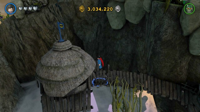 The first Gold Brick can be obtained after destroying several blue flags with Batman logo, spread around the village - Gold Bricks - Odym - secrets - LEGO Batman 3: Beyond Gotham - Game Guide and Walkthrough