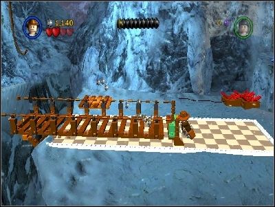 Go to the right using the bars and use your whip on the highlighted place near the edge - Chapter 2 - Into the Mountains - part 1 - Riders of the Lost Ark - LEGO Indiana Jones: The Original Adventures - Game Guide and Walkthrough