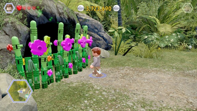 As Grant, walk to the plants blocking the access to the cave and cut them - Dilophosaurus Territory - Jurassic Park - secrets in free roam - LEGO Jurassic World - Game Guide and Walkthrough