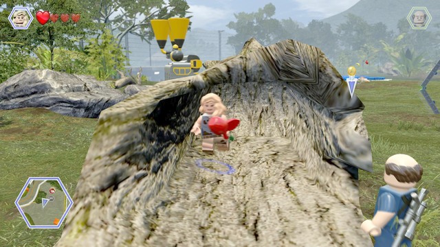 Second item, an apple, can be found hidden in tree trunk - Gallimimus Territory - Jurassic Park - secrets in free roam - LEGO Jurassic World - Game Guide and Walkthrough