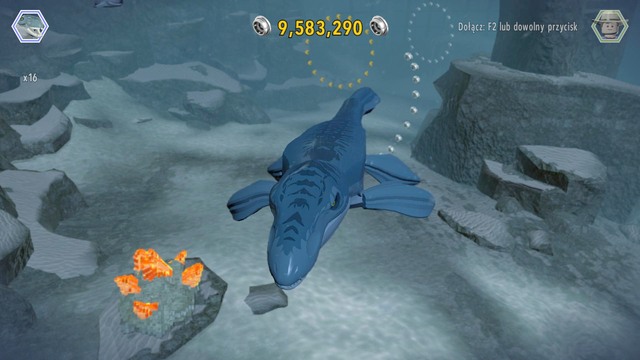 After selecting mosasaurus, swim to the amber bricks shown on the picture and destroy them with a roar - Mosasaurus Arena - Jurassic World - secrets in free roam - LEGO Jurassic World - Game Guide and Walkthrough