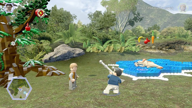 Shoot the shield hanging on the tree with a character that has a weapon - Gyrosphere Valley - Jurassic World - secrets in free roam - LEGO Jurassic World - Game Guide and Walkthrough