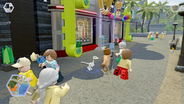 While on the street, switch your character to compsognathus and enter the green pipes shown on the picture - Main Street - Jurassic World - secrets in free roam - LEGO Jurassic World - Game Guide and Walkthrough