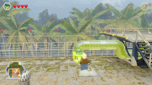 After finishing the race, change your character to compsognathus and enter the pipe - Communications Center - Jurassic Park - The Lost World - secrets in free roam - LEGO Jurassic World - Game Guide and Walkthrough