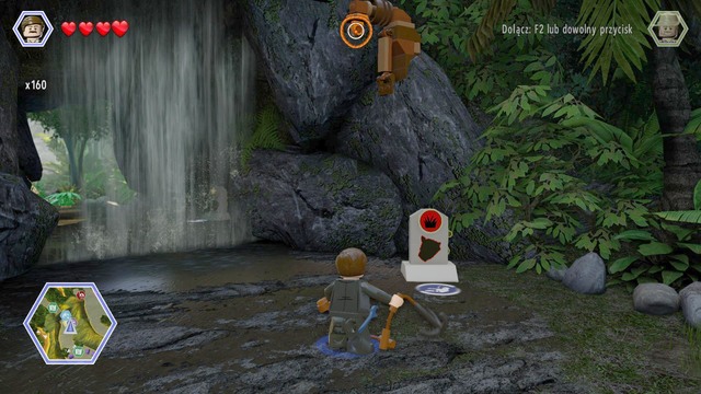 Walk to the waterfall as Paul and use the rope on the hook shown on the picture - Long Grass - Jurassic Park - The Lost World - secrets in free roam - LEGO Jurassic World - Game Guide and Walkthrough
