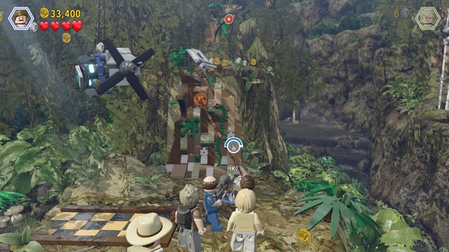 Climb up as Paul and use the rope on the catch shown in the screenshot and, as Billy, climb over the wall and take another parachute jump - Spinosaurus - Jurassic Park III - walkthrough - LEGO Jurassic World - Game Guide and Walkthrough