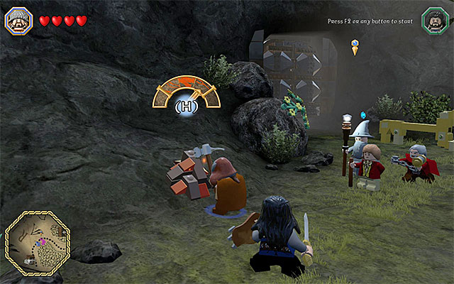Destroying the heaps of bricks, with the pickaxe allows you to obtain ingots - Middle-Earth: Reach the troll cave - Walkthrough - LEGO The Hobbit - Game Guide and Walkthrough