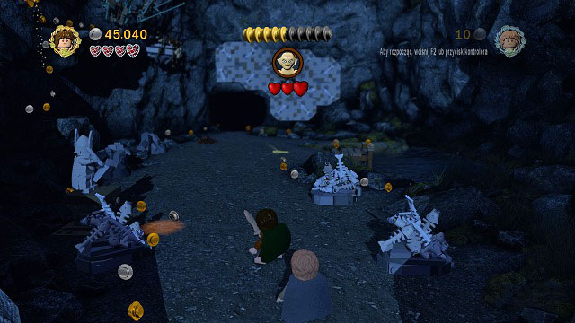 Gollum will be constantly moving along the opposite wall - to make him come down, you need to throw a fish at him - Taming Gollum - Walkthrough - Act II - LEGO The Lord of the Rings - Game Guide and Walkthrough