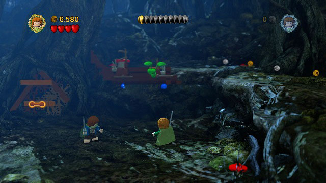 When you're done with the enemies, you will have to grab onto the log with both hobbits (press (U) after grabbing it) and build a ladder from the obtained bricks - Track Hobbits - Walkthrough - Act II - LEGO The Lord of the Rings - Game Guide and Walkthrough