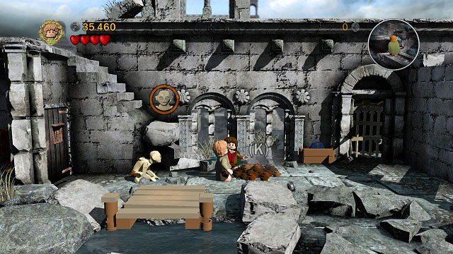 Go down the stairs and use the shovel to dig up a cog - Osgiliath - Walkthrough - Act II - LEGO The Lord of the Rings - Game Guide and Walkthrough