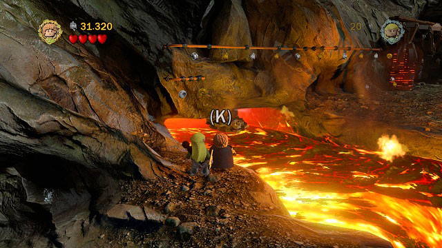 The Minikit is below the rail which you can use to avoid the lava river - Prologue - Collectibles - LEGO The Lord of the Rings - Game Guide and Walkthrough