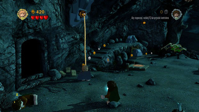 Right beside the cave you will find a hook which you can attach the rope onto - Weathertop - Collectibles - LEGO The Lord of the Rings - Game Guide and Walkthrough