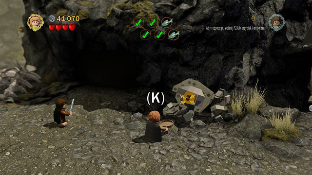 Right after the first cave in which you found a fish you should see a hook on the ground - Taming Gollum - Collectibles - LEGO The Lord of the Rings - Game Guide and Walkthrough
