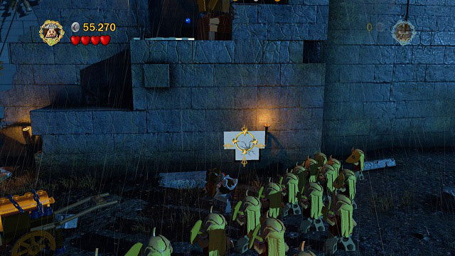 In the starting location, head right and throw Gimli at the cracked brick in the wall (you need to unveil it beforehand by destroying LEGO elements) - Helms Deep - Collectibles - LEGO The Lord of the Rings - Game Guide and Walkthrough
