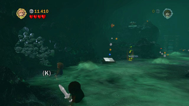 In the second big cave, on the left side there is some loose ground beside a pile of skulls - The Paths of the Dead - Collectibles - LEGO The Lord of the Rings - Game Guide and Walkthrough