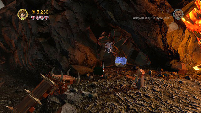 Right after crossing the first ramp you will see a pile of boulders with a skeleton hanging from them - Mount Doom - Collectibles - LEGO The Lord of the Rings - Game Guide and Walkthrough