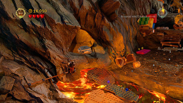 In the place where the rocks are falling down, as you're crossing the river of fire while holding onto the rail, you will see a cracked LEGO tile - Mount Doom - Collectibles - LEGO The Lord of the Rings - Game Guide and Walkthrough