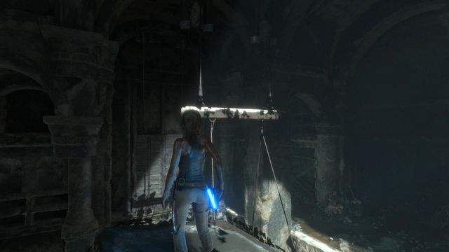 Once you stand on the pillar, notice that above the counterweight a board partially painted in white is hanging - Syria - Climb to the top of the main chamber of the tomb - Walkthrough - Rise of the Tomb Raider - Game Guide and Walkthrough