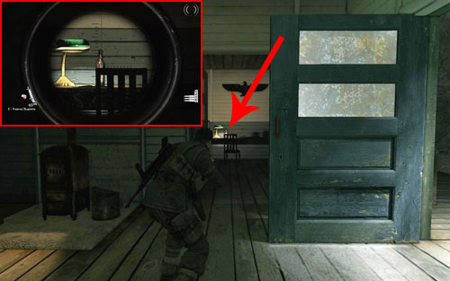 The bottle is standing on a desk inside the second building [#2] - the one which is 