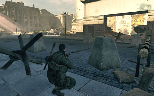 In the left corner of the square, right behind a concrete pillar beside the fenced passage [#6] - Mission 4 - Wine Bottles and Gold Bars - Sniper Elite V2 - Game Guide and Walkthrough