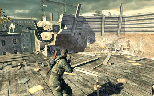 On the roof of the building [#4] inside which a soldier was walking - you can go up the rubble or use the main entrance on the corner of the street and head up the stairs to the very top - Mission 8 - Wine Bottles and Gold Bars - Sniper Elite V2 - Game Guide and Walkthrough