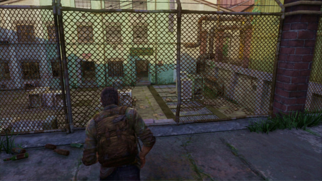 A bit further, you need to squeeze through a hole in the fence where Joel will take cover behind the crates automatically - The Slum (text & map) - The Quarantine Zone - The Last of Us - Game Guide and Walkthrough