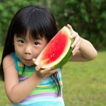 Chinese small girl with a watermelon