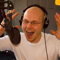 A singer with headphones in a studio