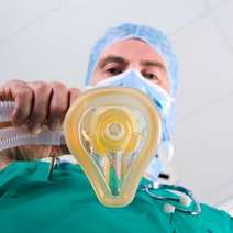 Anaesthetist holding an oxygen mask
