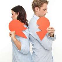 Young couple holding two parts of orange heart