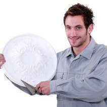 Man holding a large white ceramic dish