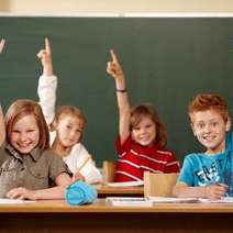 Children at school with their hands up
