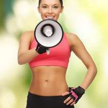 Woman in sports outfit holding an amplifier