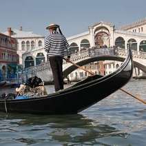 Person driving a gondola on the water