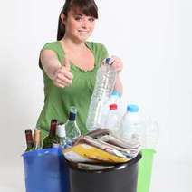 Woman showing thumb up over separated waste