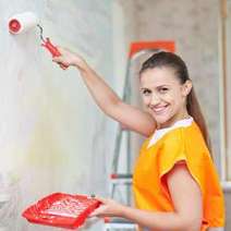 Woman painting a wall