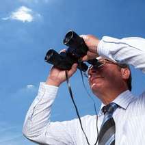  A man looking through binoculars