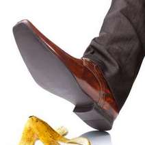  A male's shoe stepping on a banana peel