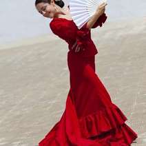  A Spanish woman in red dress holding a spread