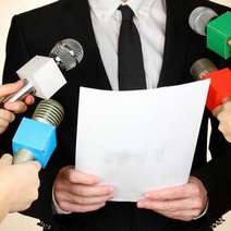  Man reading from a paper on a press conference