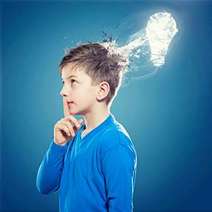  A boy thinking with a radiant light bulb over his head
