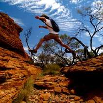  A hiker jumping over glen