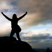  A woman reaching the top of a hill