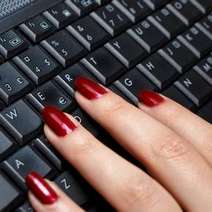  Woman's hand typing on a keyboard