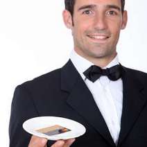  A waiter holding a tray with a credit card