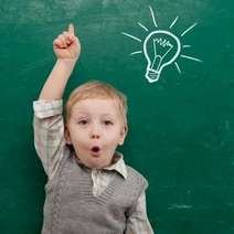  Boy with drawing of a light bulb on a chalkboard