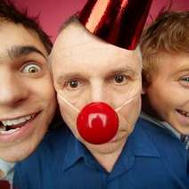  Selfie of men, one of them wearing red clown nose and party cap
